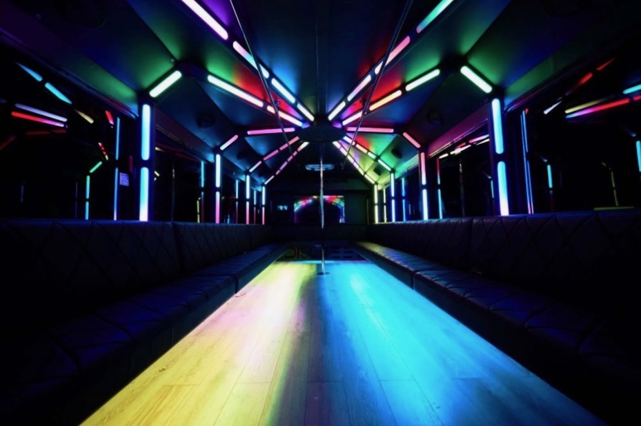 35 Passenger Party Bus Rentals Bus Inside with rainbow lights.