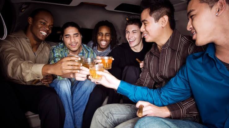 Exciting Bachelor Party Bus Rental Las Vegas 2 Friends celebrating with drinks together.